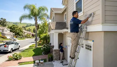 Professional house painters working on residential exterior in San Francisco, CA