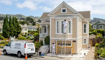 Professional house painters in San Francisco CA applying exterior paint to a modern residential home